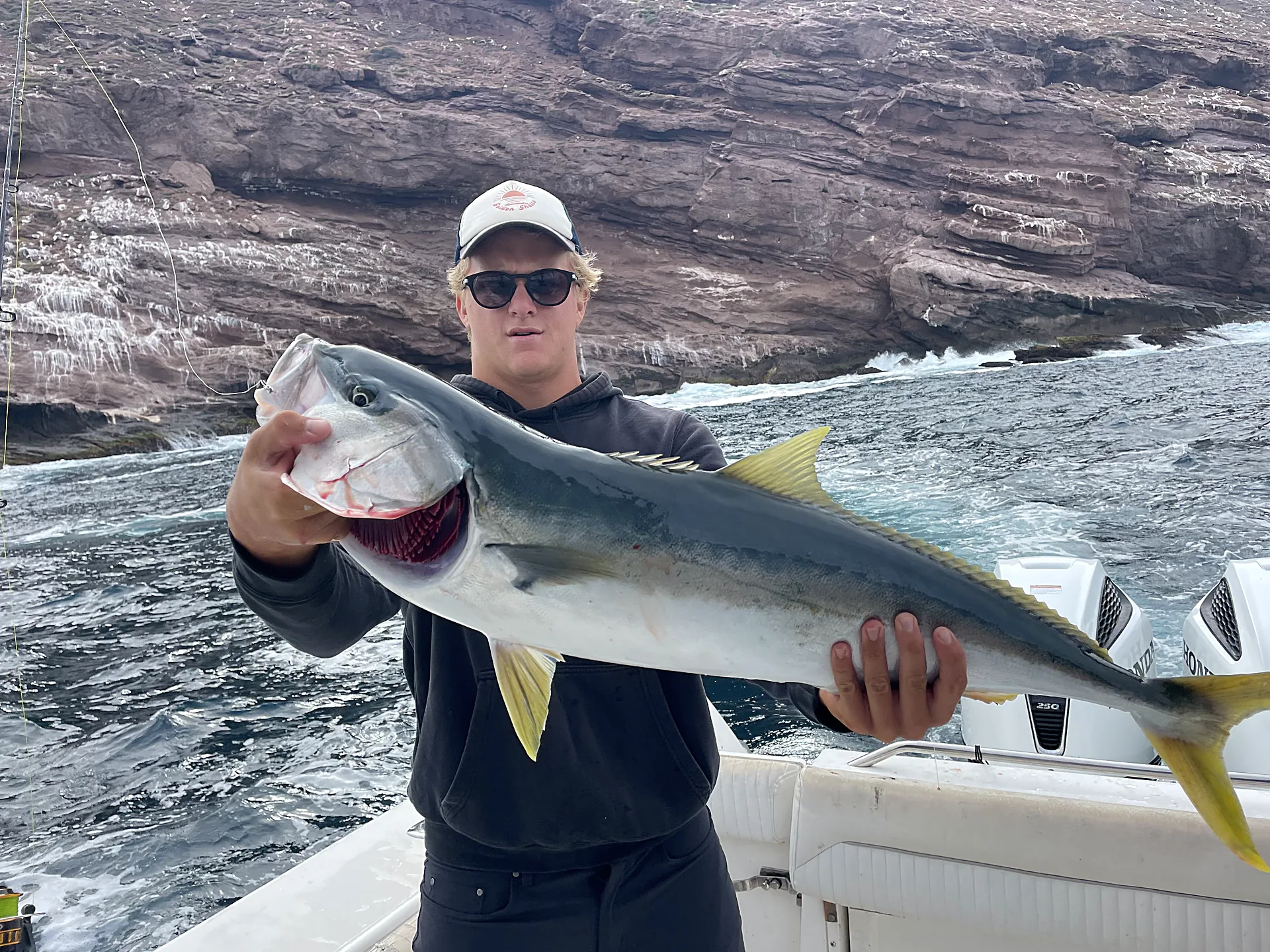 An angler holding a large yellowtail caught at the Coronado Islands on a Fernandez Charter