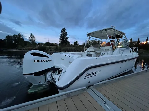 The Boston Whaler 285 Conquest at rest on glassy water.