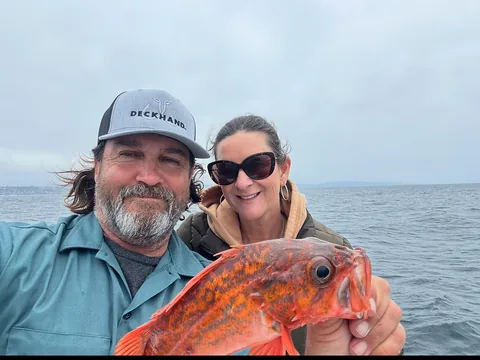 Captain Pablo and a guest with a bright vermilion rockfish.