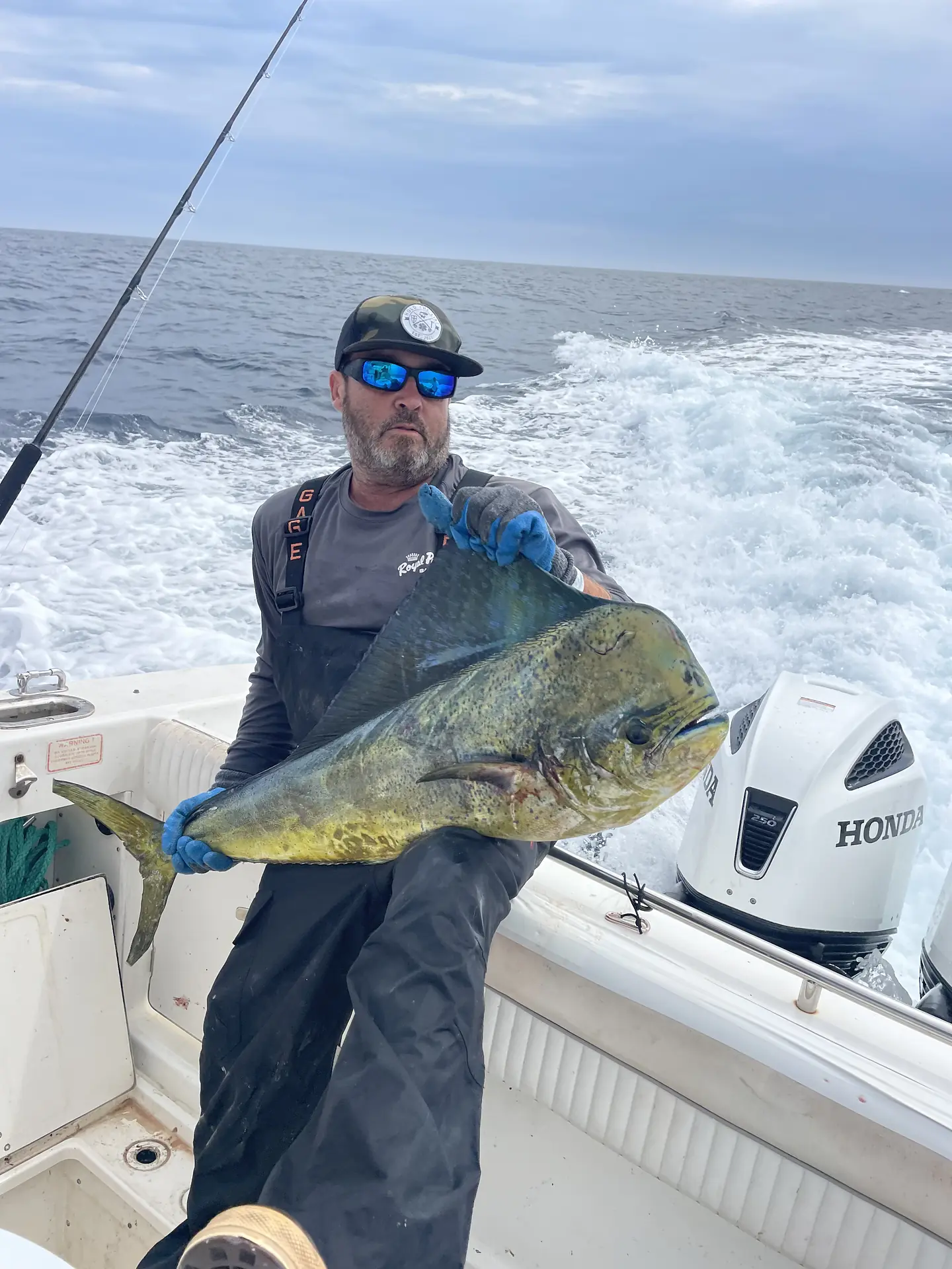 Captain Pablo Fernandez holding a dorado aboard the Kate Elizabeth